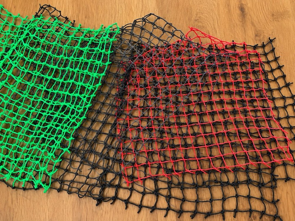 Green, black and red knotted netting samples